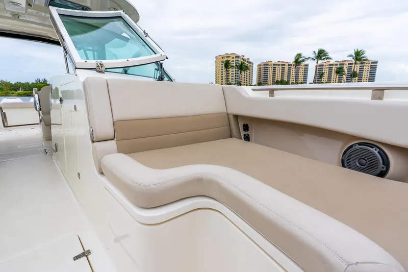 Slide: The Image of 2017 Boston Whaler 320 Vantage boat interior with beige seating and speaker. - 39