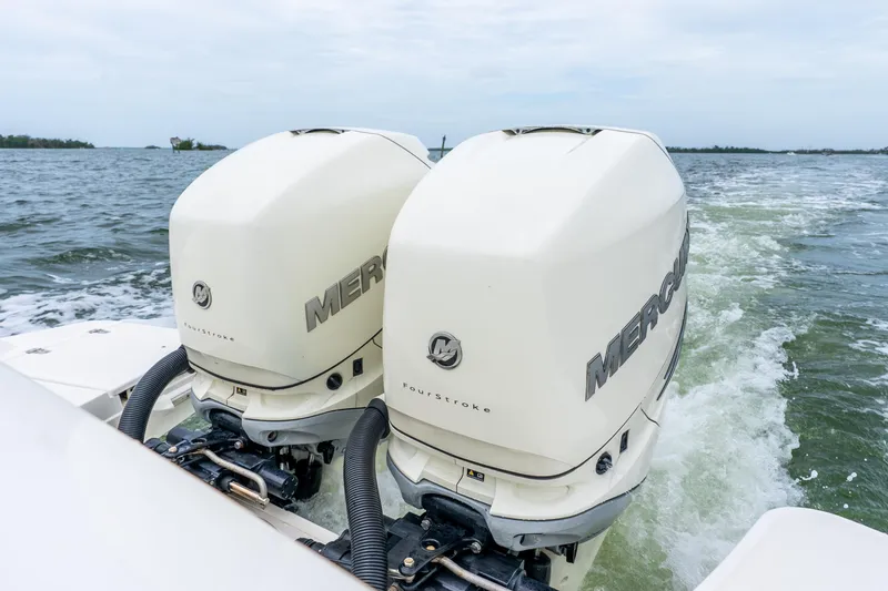 Slide: The Image of Twin Mercury outboard engines on a 2017 Boston Whaler 320 Vantage boat in motion. - 41