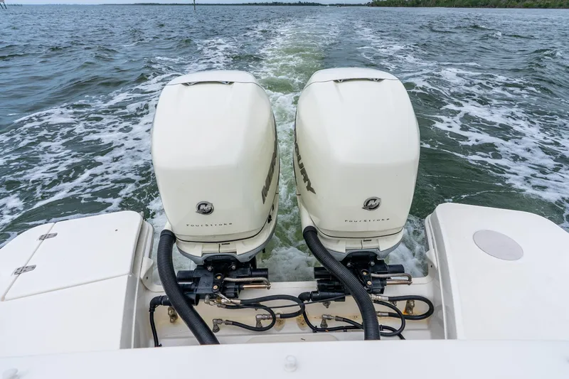 Slide: The Image of 2017 Boston Whaler 320 Vantage with twin Mercury outboard engines on open water. - 42