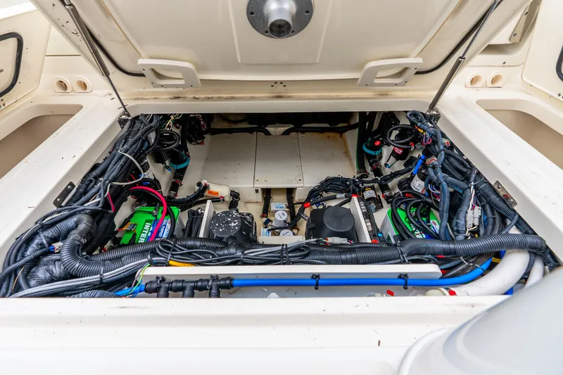 Slide: The Image of Engine compartment of a 2017 Boston Whaler 320 Vantage, showcasing wiring and components. - 44