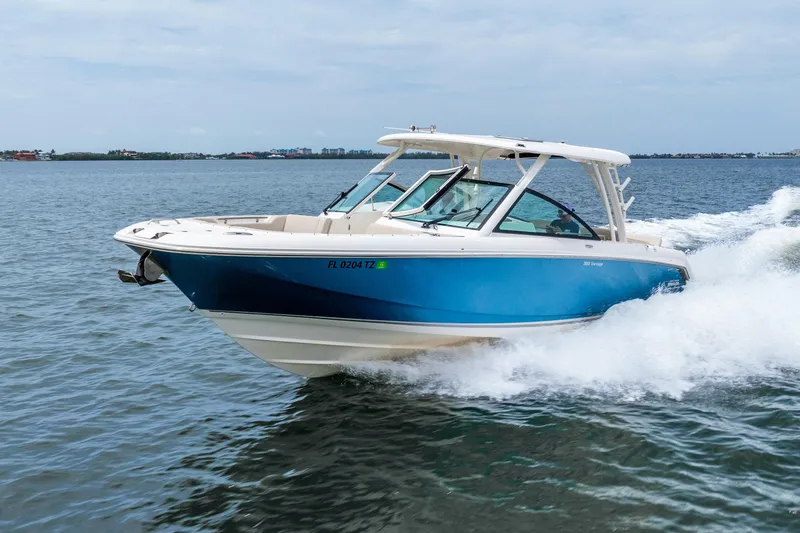 Slide: The Image of Manufacturer Provided Image: 2017 Boston Whaler 320 Vantage boat interior with beige seating and a kitchenette. - 9