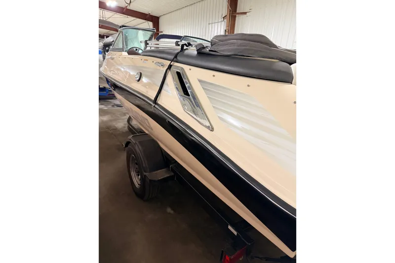 Slide: The Image of 2007 Bombardier Seadoo Utopia boat on trailer in indoor storage facility. - 14