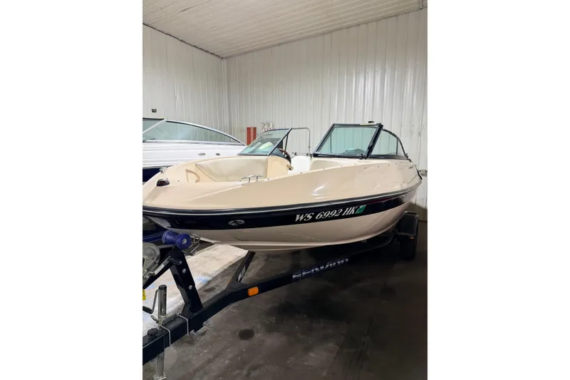 Slide: The Image of 2007 Bombardier Seadoo Utopia boat on trailer in indoor storage. - 16
