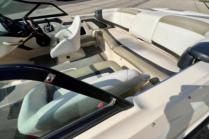 Slide: The Image of Interior of a 2007 Bombardier Seadoo Utopia boat with white seating and steering wheel. - 5