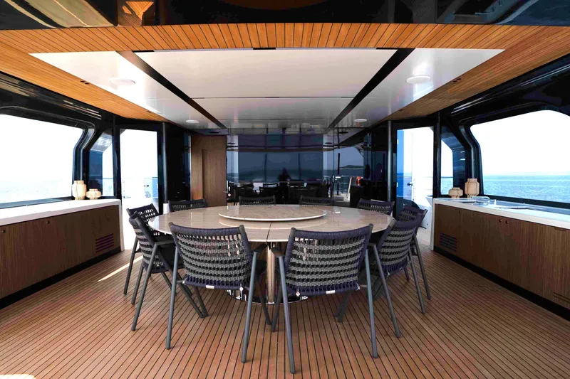 Slide: The Image of Luxurious dining area on 2025 Alpha 100 Squalo Co Ownership yacht, featuring modern design. - 16