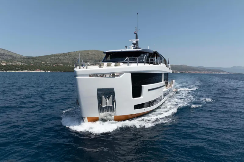 Slide: The Image of Luxurious 2025 Alpha 100 Squalo Co Ownership yacht cruising on open sea. - 2