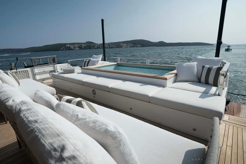 Slide: The Image of Luxurious 2025 Alpha 100 Squalo yacht deck with plush seating and scenic ocean view. - 20