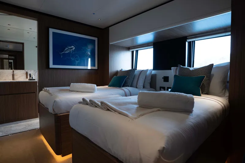 Slide: The Image of Luxurious cabin interior of 2025 Alpha 100 Squalo Co Ownership yacht, featuring twin beds and elegant decor. - 32