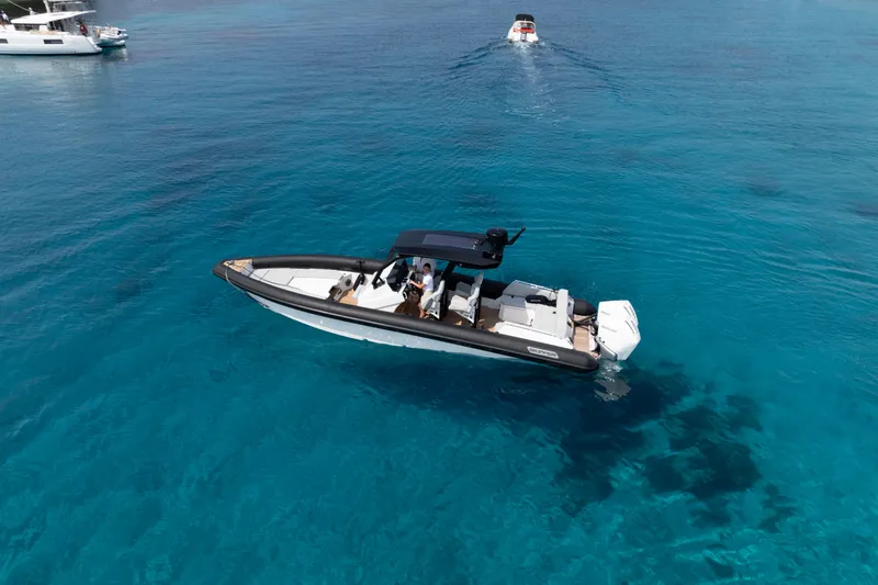 Slide: The Image of 2025 Alpha 100 Squalo Co Ownership boat cruising on clear blue water. - 43