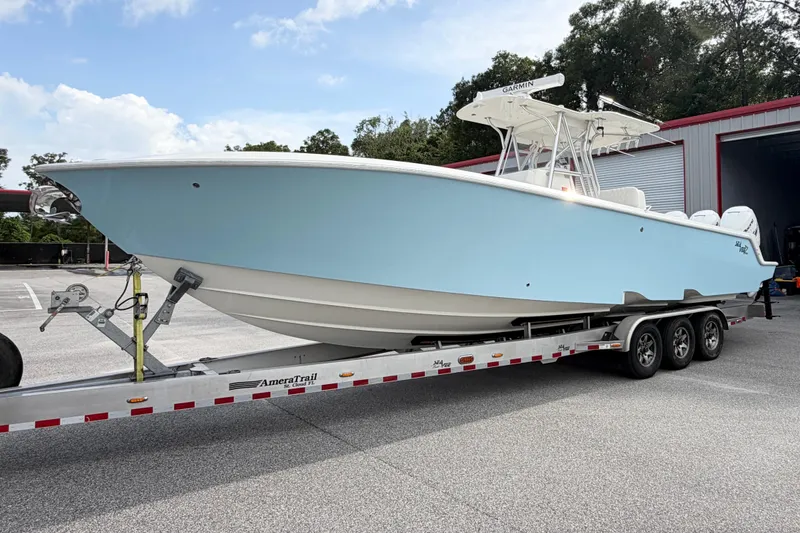 The Image of 2017 SeaVee 340Z boat on trailer, light blue hull, parked outdoors. - 0