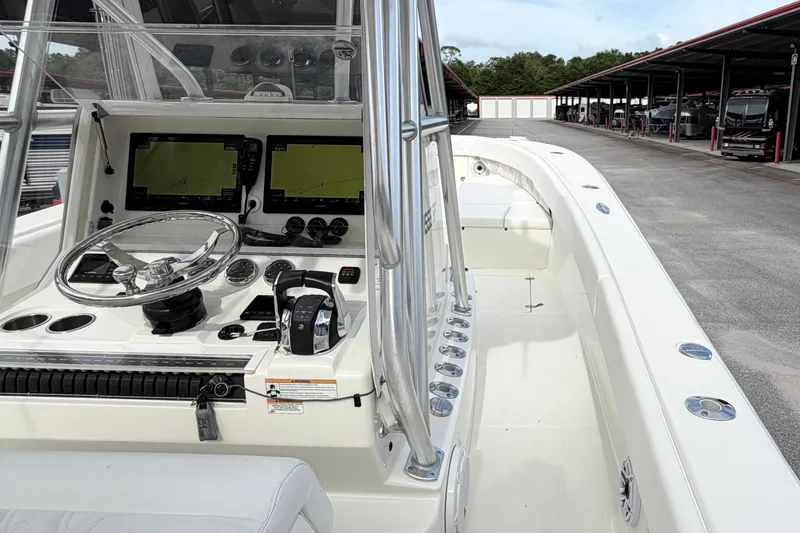 Slide: The Image of 2017 SeaVee 340Z boat cockpit with dual navigation screens and sleek steering wheel. - 10