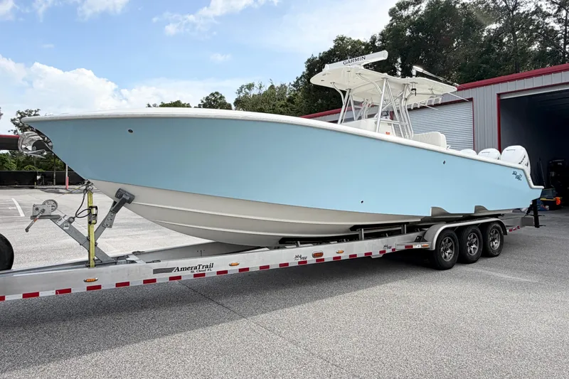 Slide: The Image of 2017 SeaVee 340Z boat on trailer, light blue hull, parked outdoors. - 3