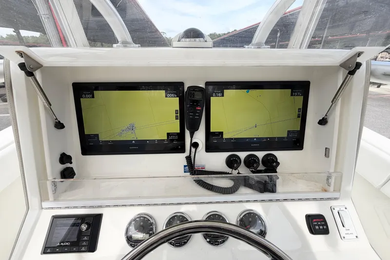 Slide: The Image of 2017 SeaVee 340Z boat dashboard with dual Garmin displays and navigation controls. - 5