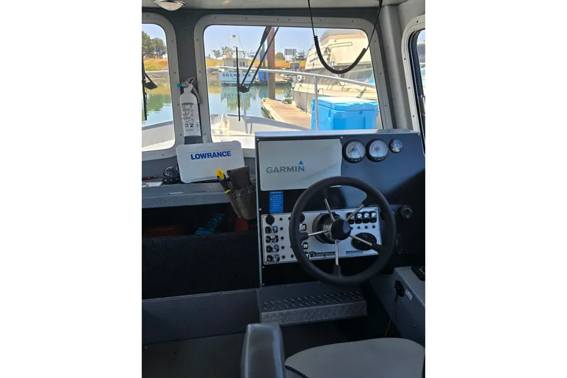 Slide: The Image of Interior of 2021 KingFisher 2825 Coastal Express boat with Garmin and Lowrance equipment. - 1