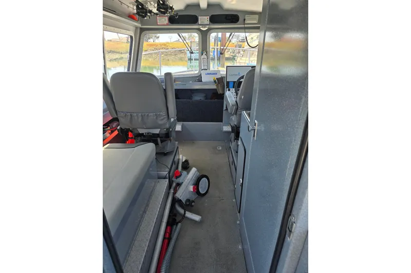 Slide: The Image of Interior of 2021 KingFisher 2825 Coastal Express boat, featuring seating and navigation equipment. - 2