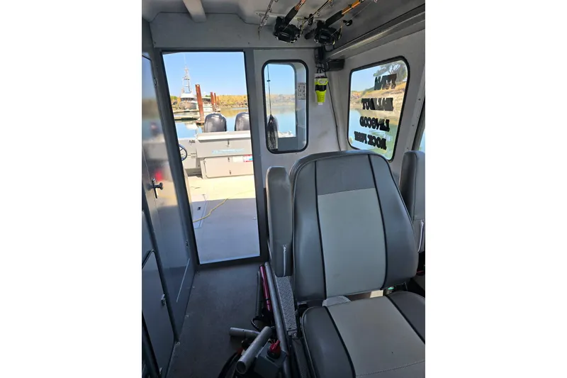 Slide: The Image of Interior view of 2021 KingFisher 2825 Coastal Express boat with seating and open door. - 3