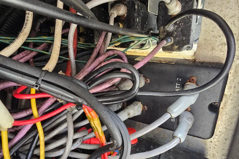 Slide: The Image of Tangled wiring inside a 2021 KingFisher 2825 Coastal Express boat. - 31