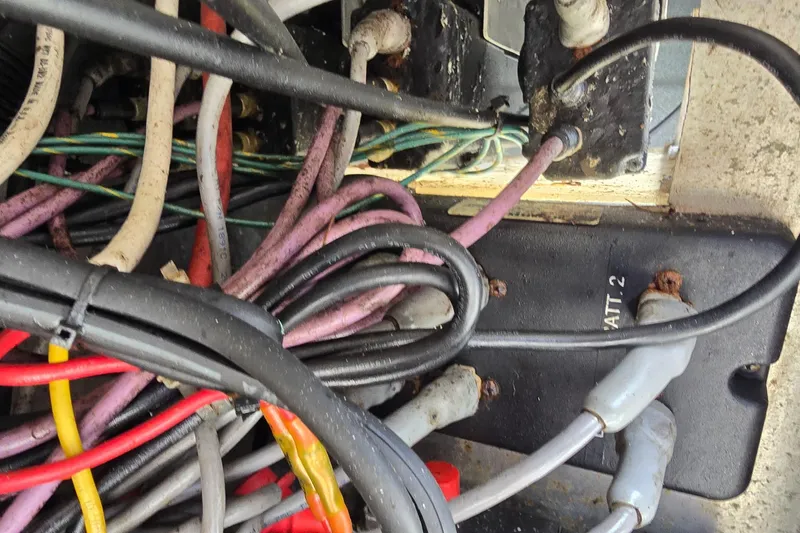 Slide: The Image of Tangled wiring inside a 2021 KingFisher 2825 Coastal Express boat. - 32