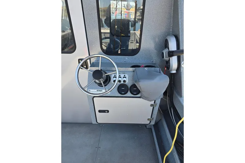 Slide: The Image of 2021 KingFisher 2825 Coastal Express helm with steering wheel and control panel. - 5