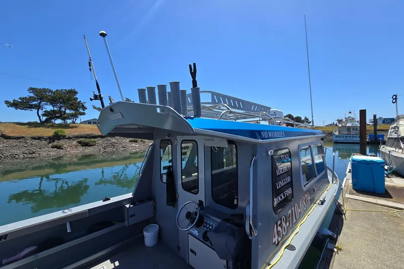 Slide: The Image of 2021 KingFisher 2825 Coastal Express docked by a serene waterfront. - 6