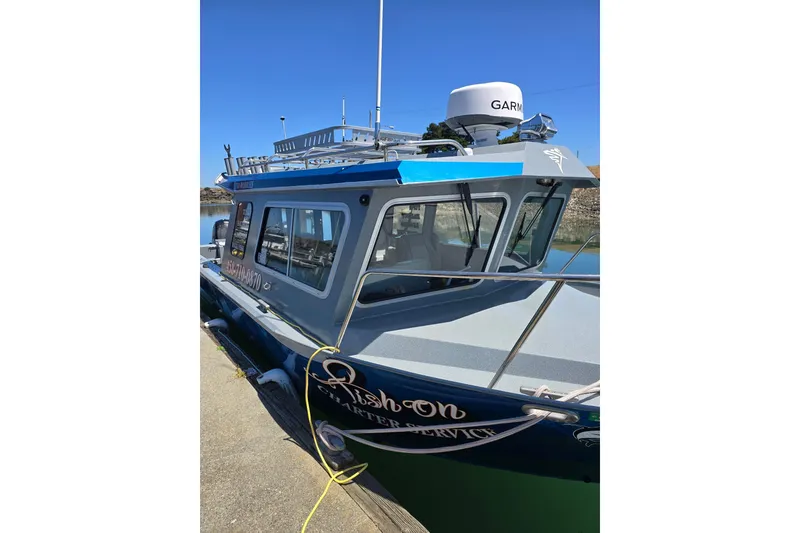 Slide: The Image of 2021 KingFisher 2825 Coastal Express boat docked, featuring Garmin equipment. - 7