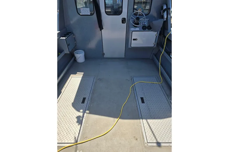 Slide: The Image of Interior of 2021 KingFisher 2825 Coastal Express boat with steering wheel and storage compartments. - 9