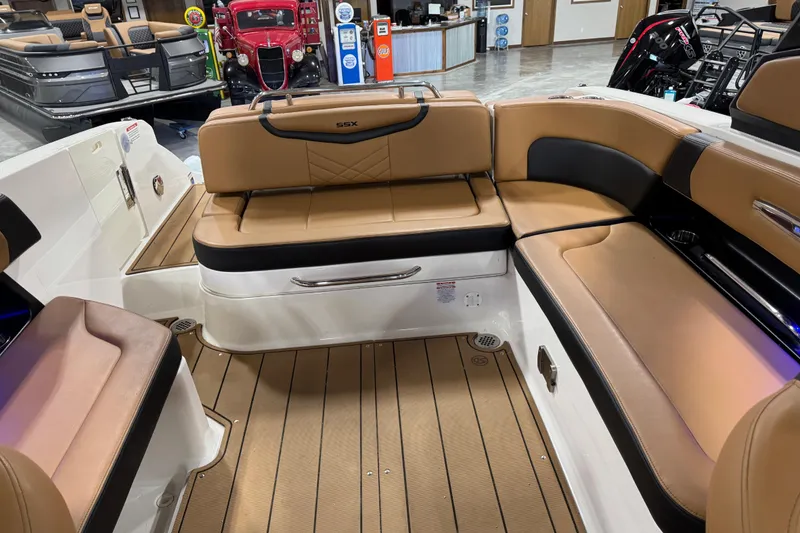 Slide: The Image of 2021 Chaparral 287 SSX boat interior with tan leather seating and wood flooring. - 10