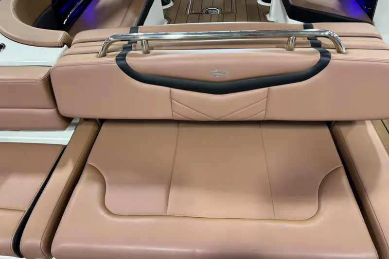 Slide: The Image of 2021 Chaparral 287 SSX boat interior with tan leather seating and stainless steel accents. - 12