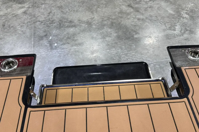 Slide: The Image of 2021 Chaparral 287 SSX boat deck with cup holders on a concrete floor. - 14