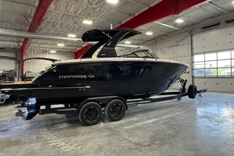Slide: The Image of 2021 Chaparral 287 SSX boat on trailer in spacious indoor storage facility. - 3