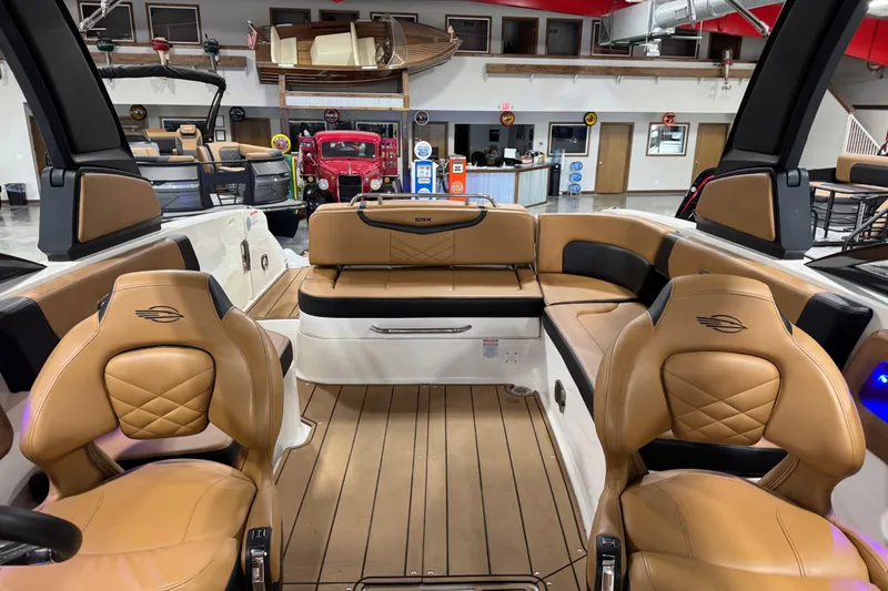 Slide: The Image of 2021 Chaparral 287 SSX boat interior with tan leather seating and wood flooring. - 5