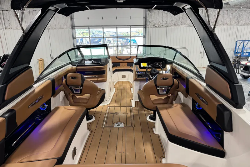 Slide: The Image of 2021 Chaparral 287 SSX boat interior with luxurious seating and modern dashboard. - 9