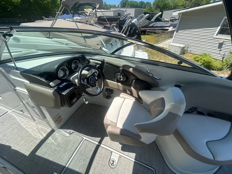 Slide: The Image of Interior of a 2019 Crownline E255XS boat with steering console. - 14