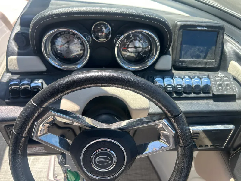 Slide: The Image of Dashboard of a 2019 Crownline E255XS boat with steering wheel and gauges. - 15