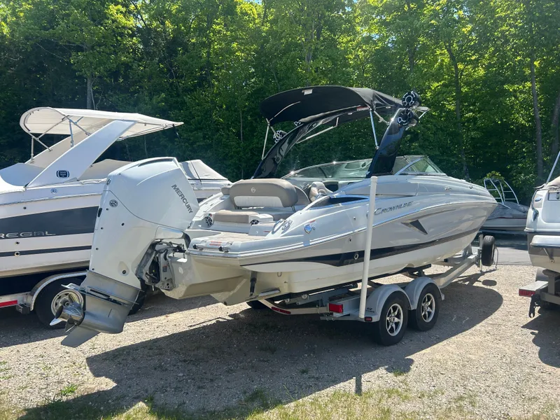 Slide: The Image of 2019 Crownline E255XS boat on trailer outdoors. - 3
