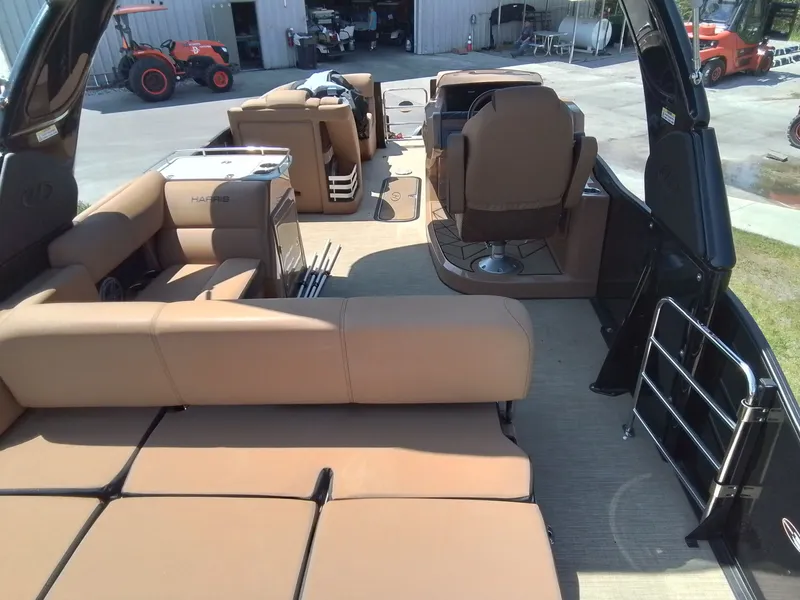 Slide: The Image of Interior of a 2023 Harris 230 GRAND MARIN pontoon boat with brown seating. - 11