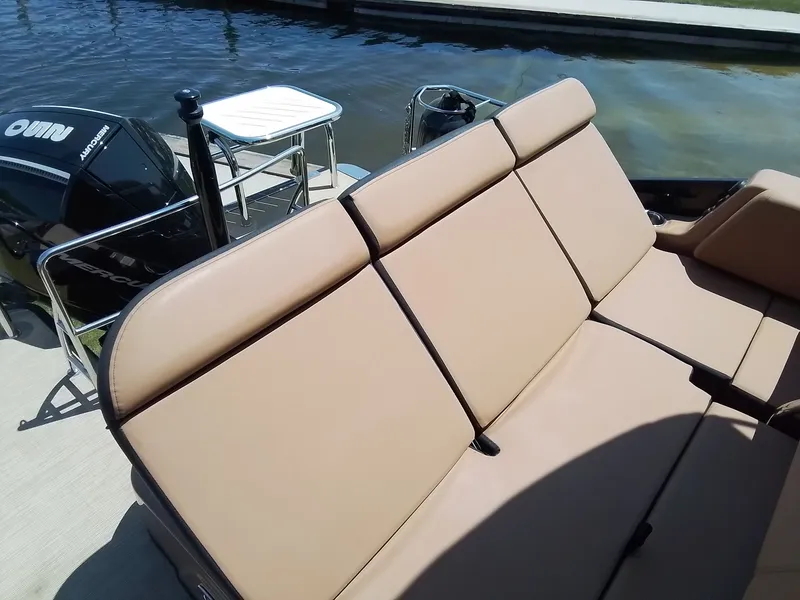 Slide: The Image of Harris 230 GRAND MARIN 2023 with beige seating area and outboard motor. - 22