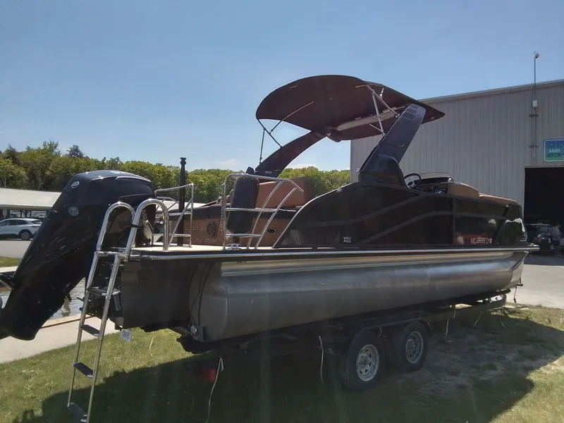 Slide: The Image of 2023 Harris 230 Grand Marin pontoon boat on trailer outdoors. - 3