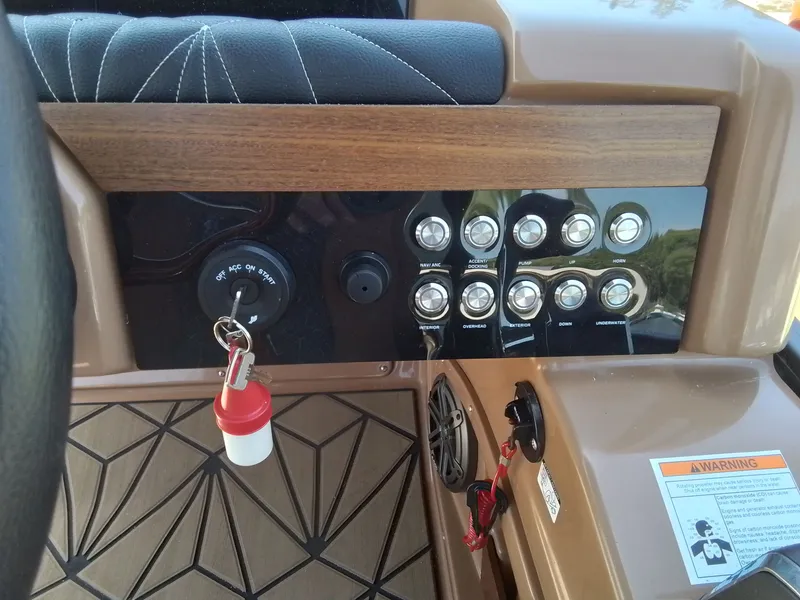 Slide: The Image of Dashboard of 2023 Harris 230 GRAND MARIN with switches and ignition key. - 31