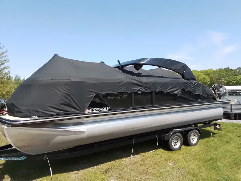 Slide: The Image of 2023 Harris 230 GRAND MARIN pontoon boat with cover on trailer. - 4