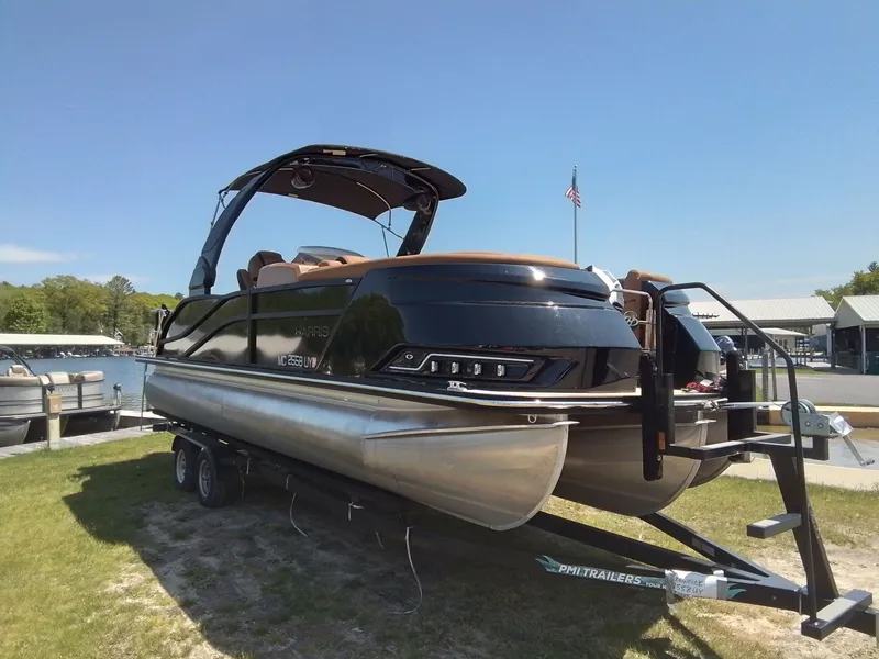 Slide: The Image of 2023 Harris 230 GRAND MARIN pontoon boat on trailer by the lake. - 6