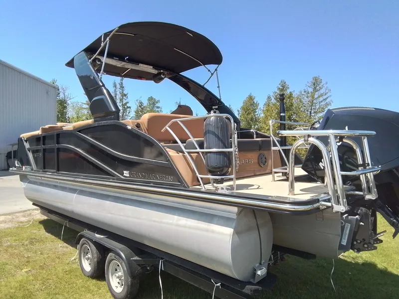 Slide: The Image of 2023 Harris 230 Grand Marin pontoon boat on trailer outdoors. - 9