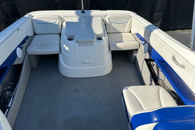 Slide: The Image of 2007 Bayliner Discovery 215 boat interior with seating and cup holders. - 2