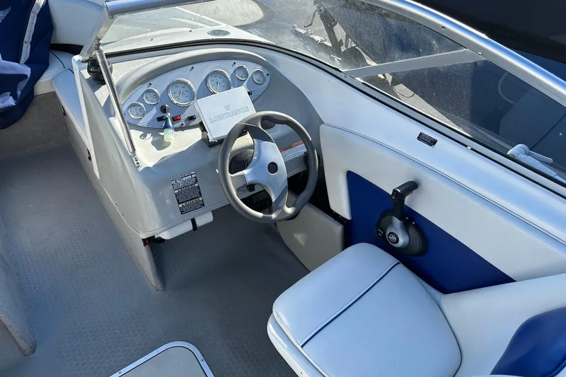 Slide: The Image of 2007 Bayliner Discovery 215 boat cockpit with steering wheel and instrument panel. - 6