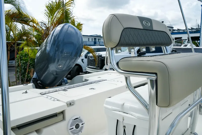 Slide: The Image of 2025 Key West 210 Bay Reef boat with Yamaha outboard motor and cushioned seating. - 15