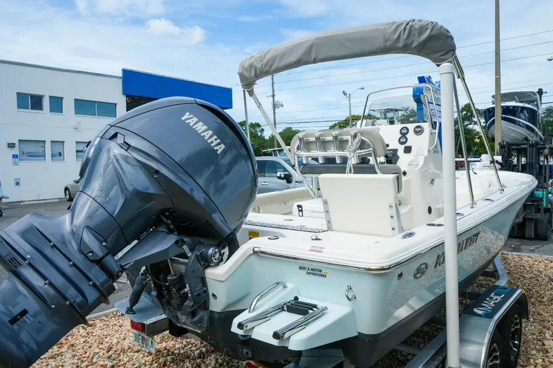 Slide: The Image of 2025 Key West 210 Bay Reef boat with Yamaha engine, displayed outdoors. - 18