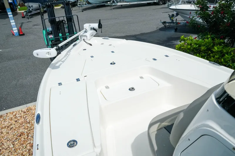 Slide: The Image of 2025 Key West 210 Bay Reef boat deck with trolling motor in a marina setting. - 25
