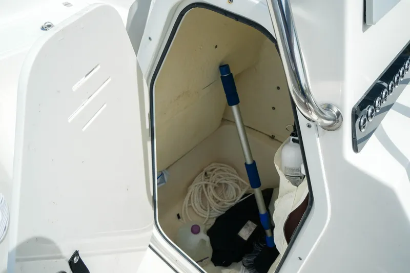 Slide: The Image of Storage compartment of 2025 Key West 210 Bay Reef boat with equipment and supplies. - 26