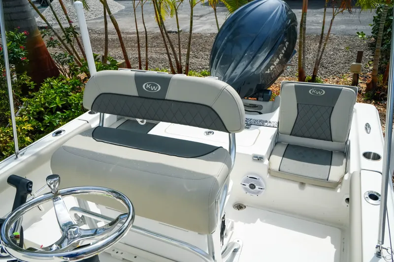 Slide: The Image of 2025 Key West 210 Bay Reef boat interior with seating and steering wheel. - 28