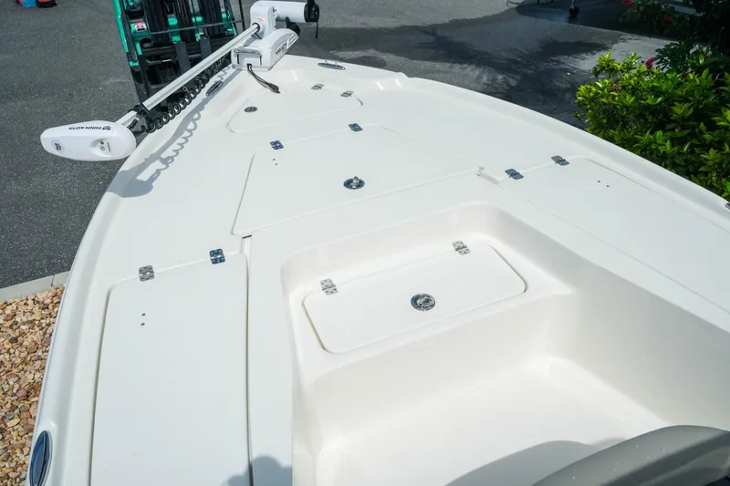 Slide: The Image of 2025 Key West 210 Bay Reef boat deck with storage compartments and trolling motor. - 29